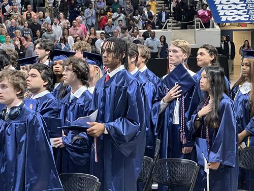 Students at attention in Bob Jones High School caps and gowns